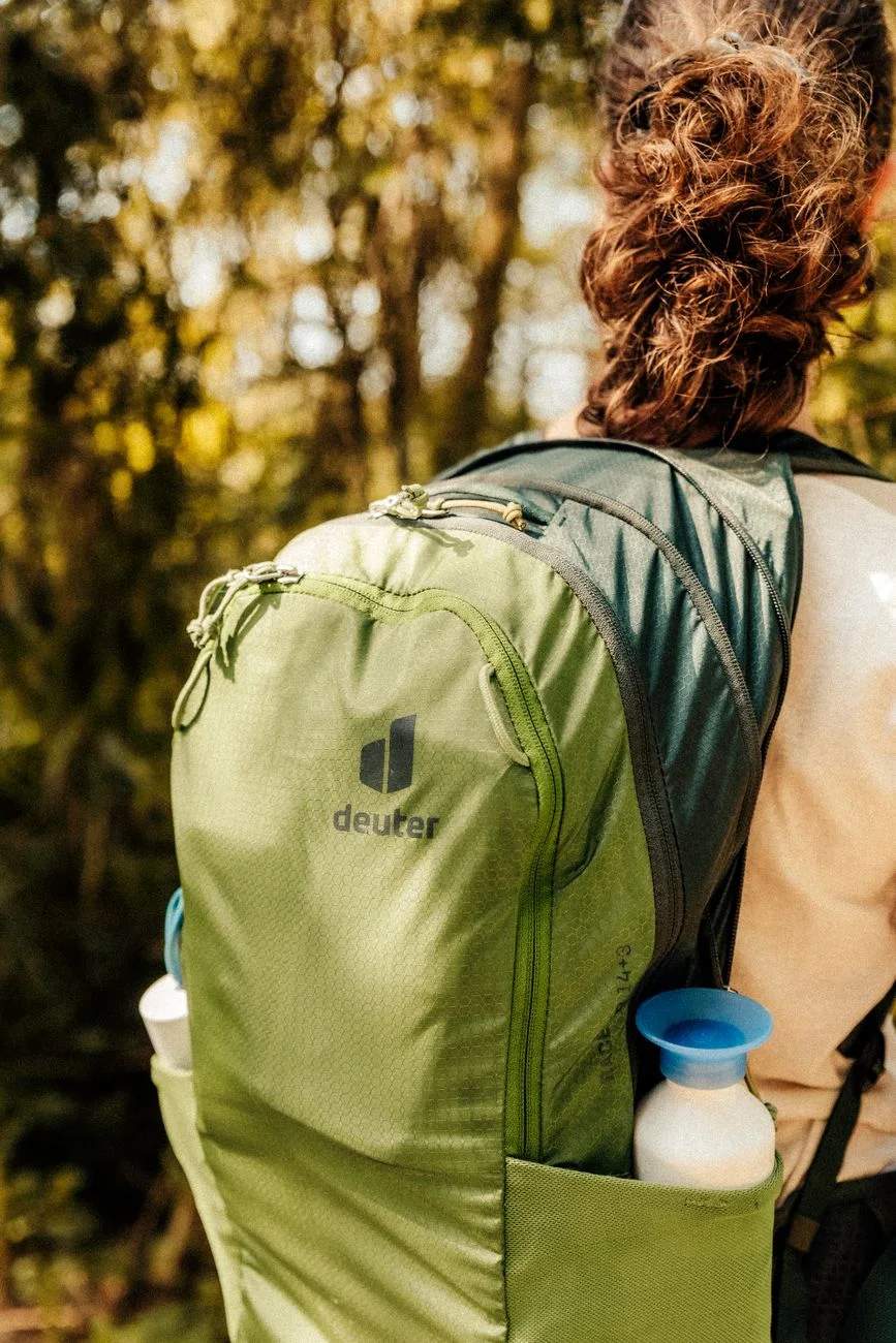 Hiker carrying a day pack on a forest trail
