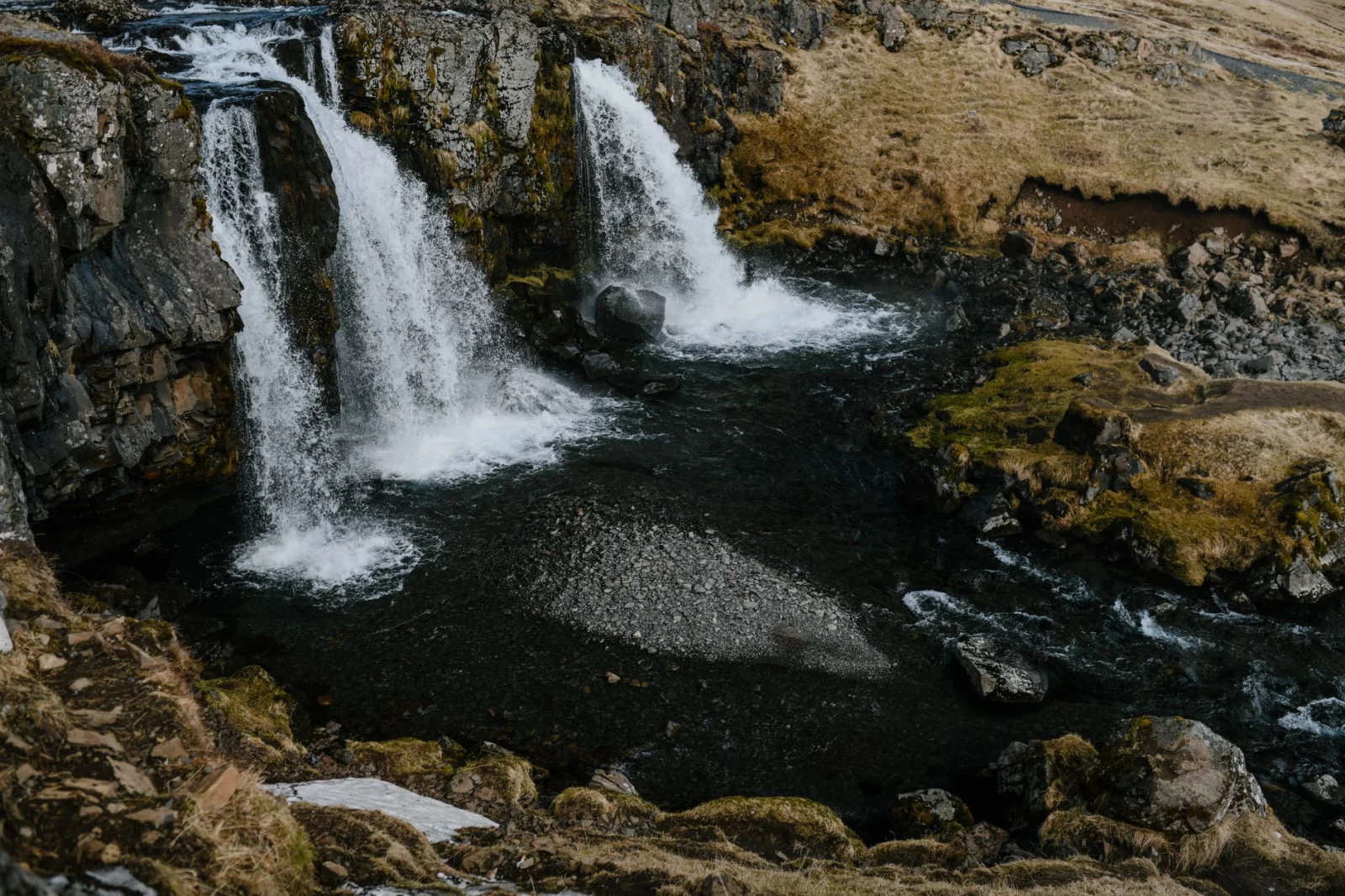 Stunning aerial capture of Glymur Waterfall cascading through lush green Icelandic terrain.