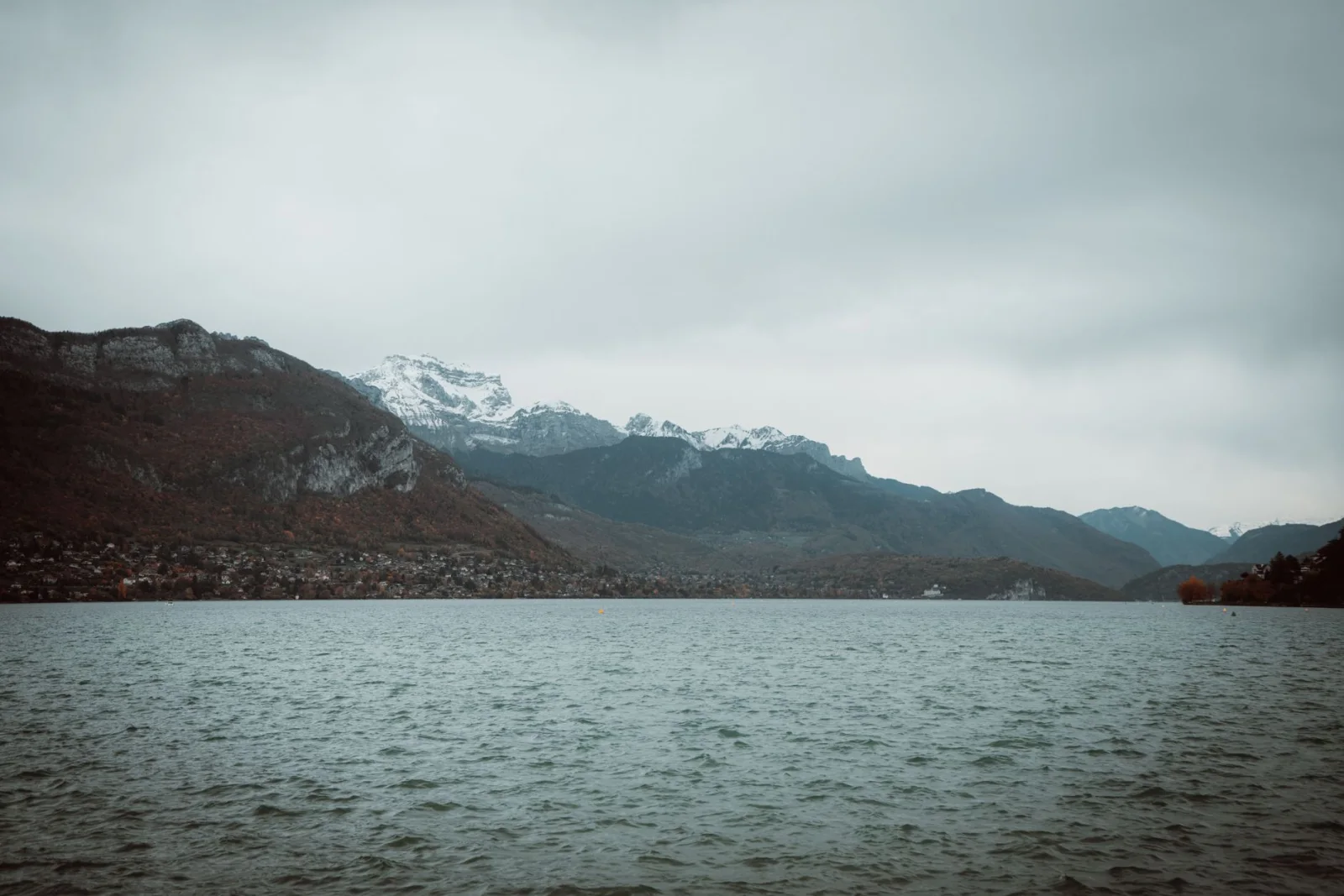 Lake Annecy with snow-capped Alps mountains in autumn