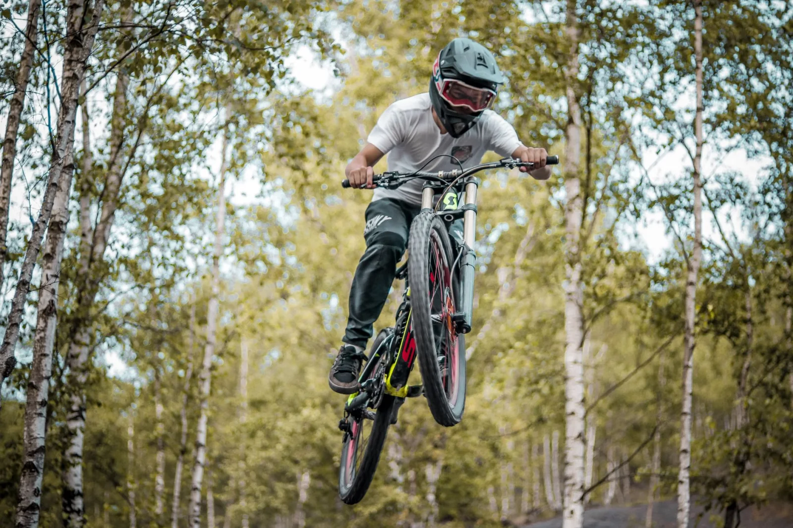 Mountain biker jumping on a trail in the French Alps