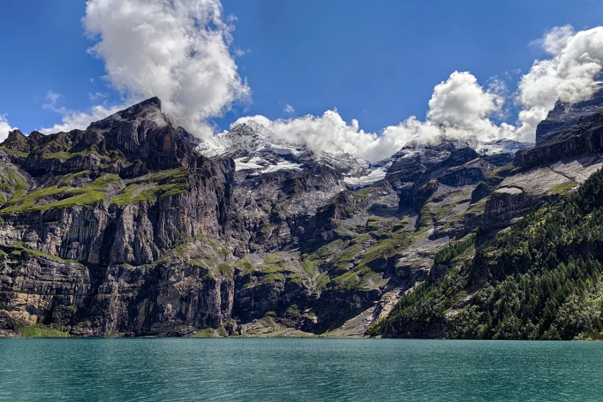 Oeschinensee lake beneath steep Alpine rock walls in Switzerland