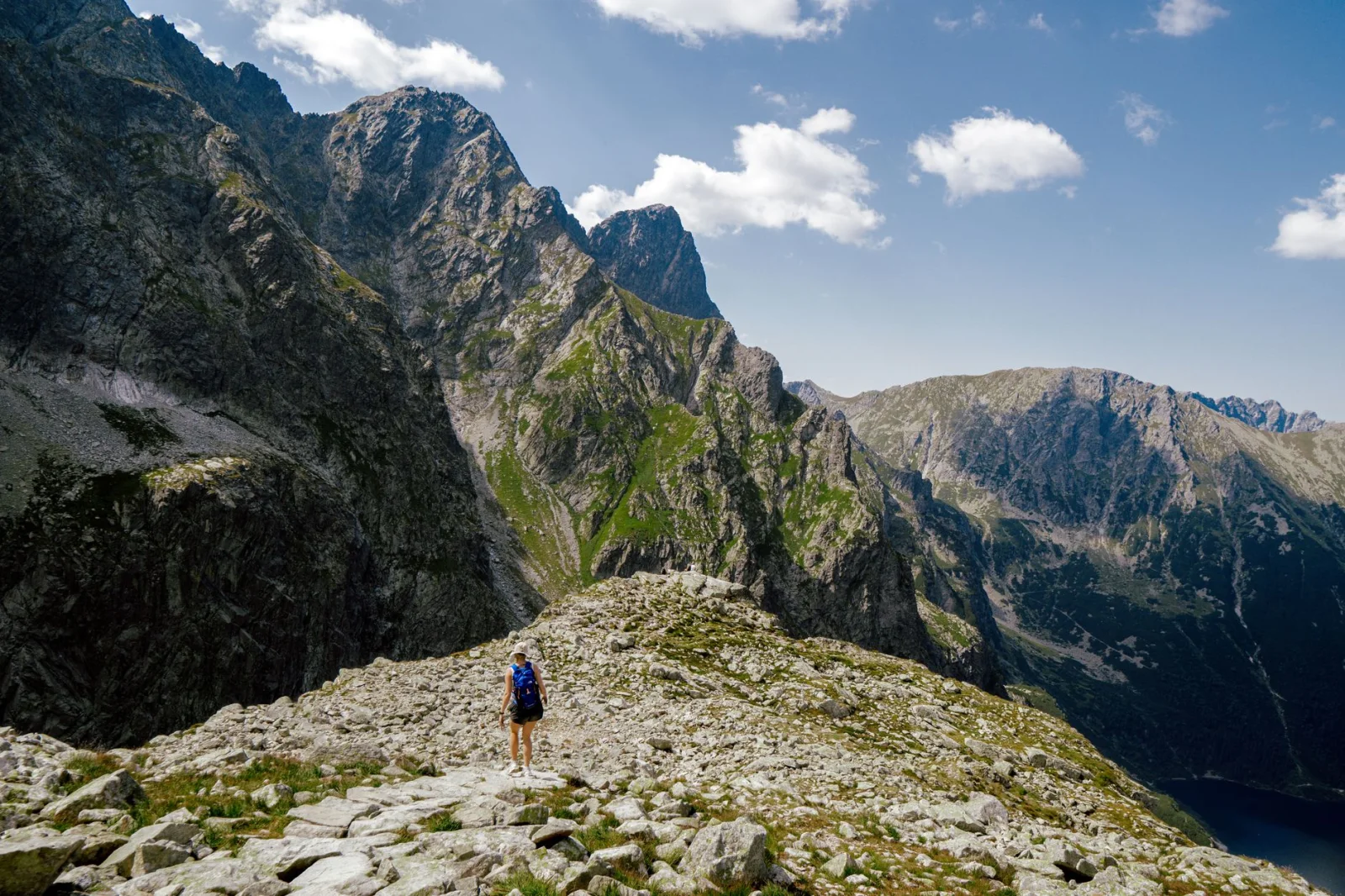 Hiker standing on a rocky ridge in the Tatra Mountains near Zakopane