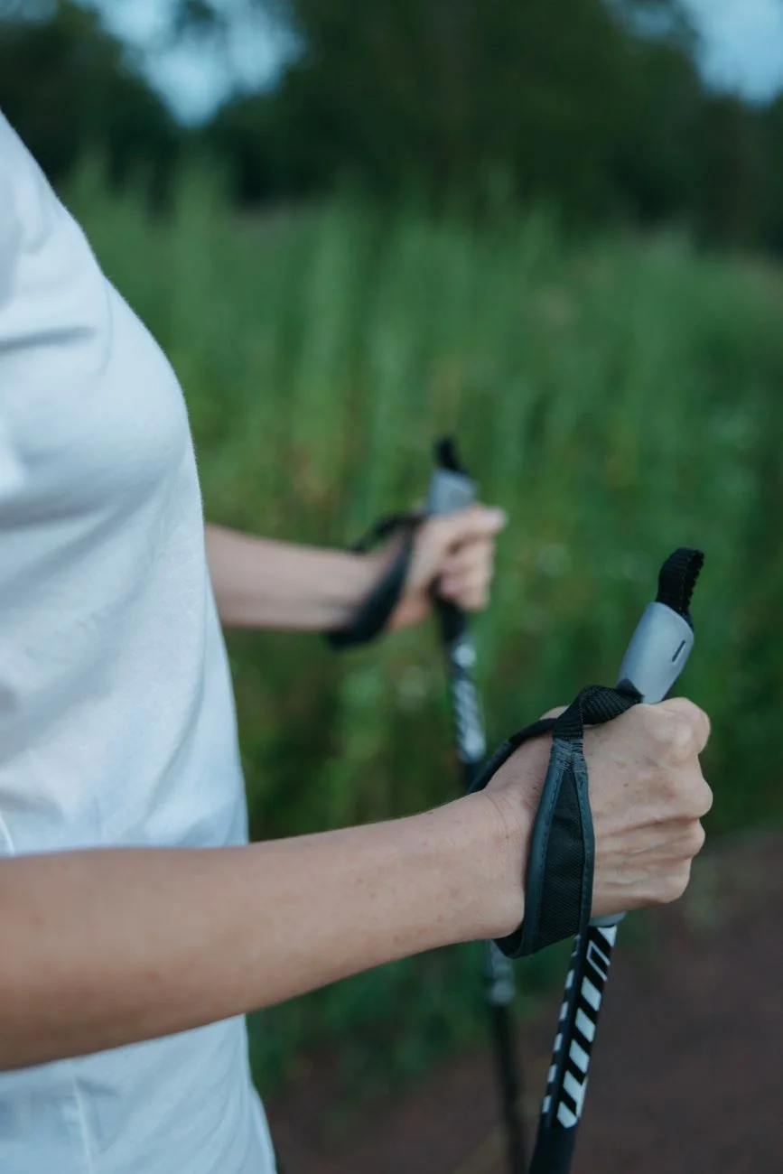 Hiker holding trekking poles outdoors