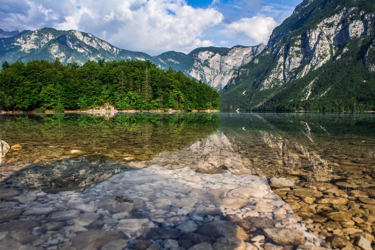 Turquoise water and forested shoreline at Lake Bohinj, Slovenia